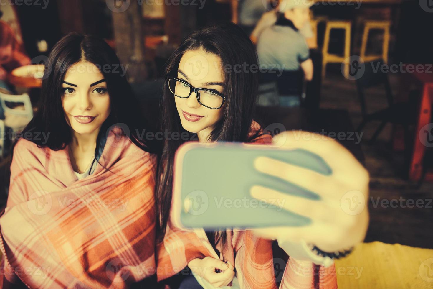 two close friends do selfie in the cafe photo