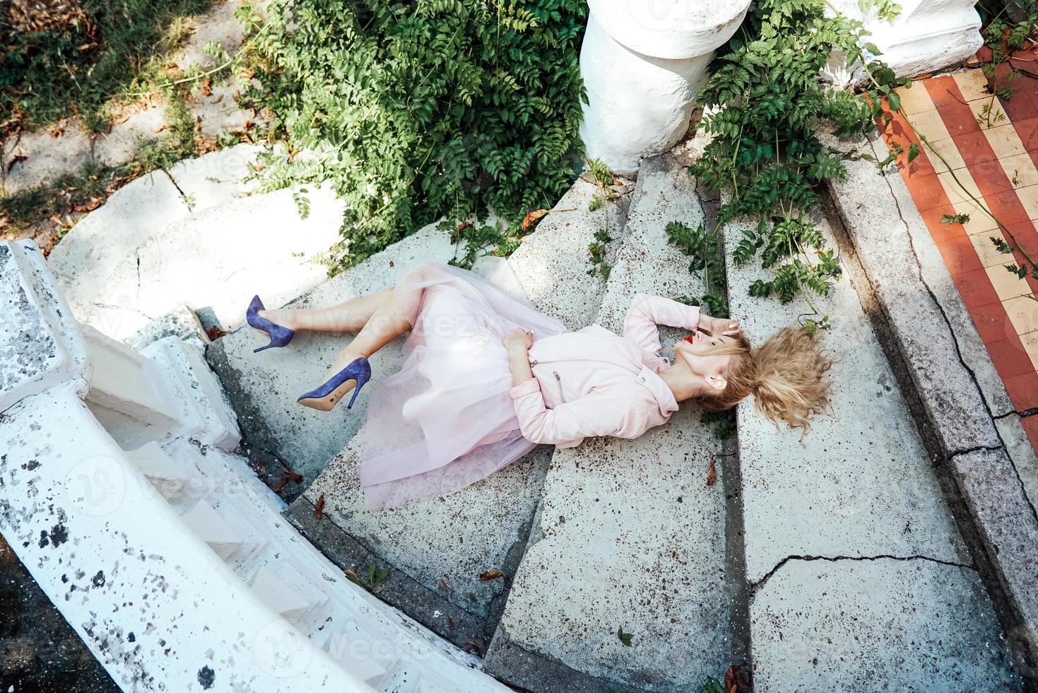 Girl is posing on the stone steps photo