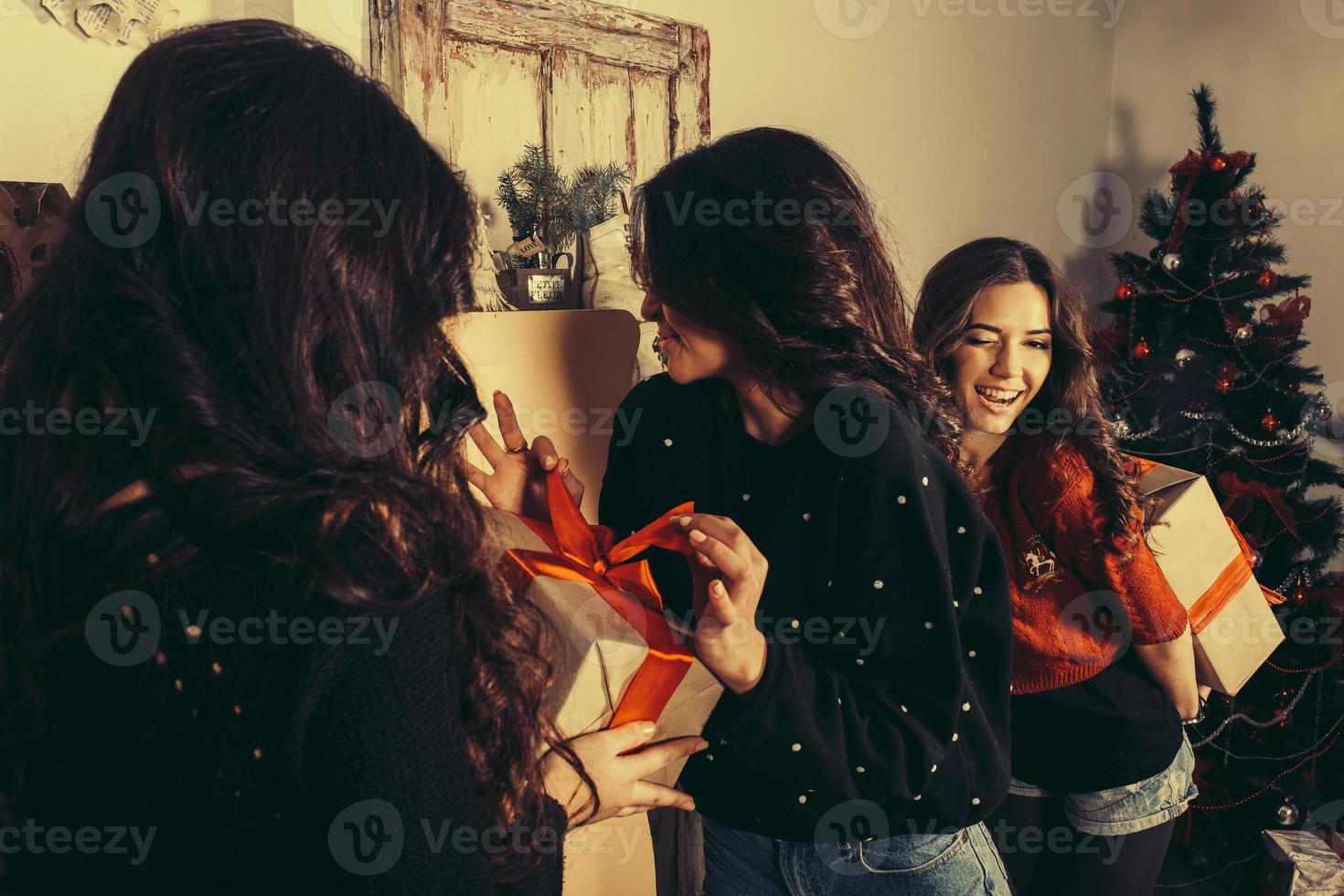 Beautiful girl exchange gifts for the new year. Decorative vintage apartment. photo
