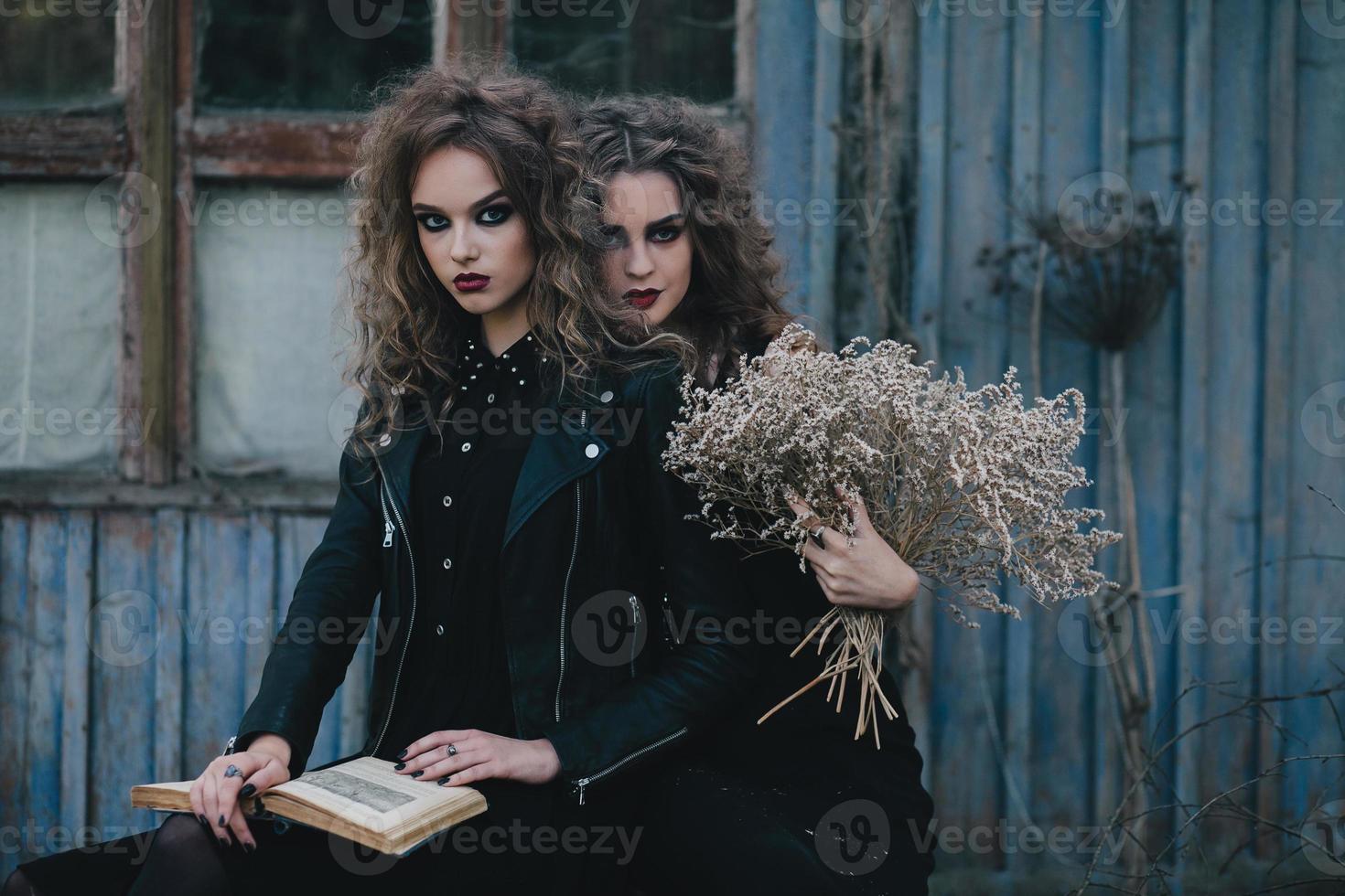 Two vintage witches gathered eve of Halloween photo