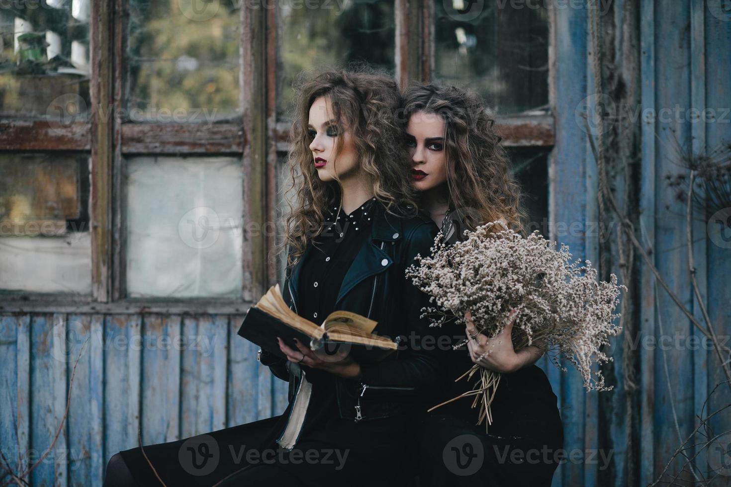 Two vintage witches gathered eve of Halloween photo