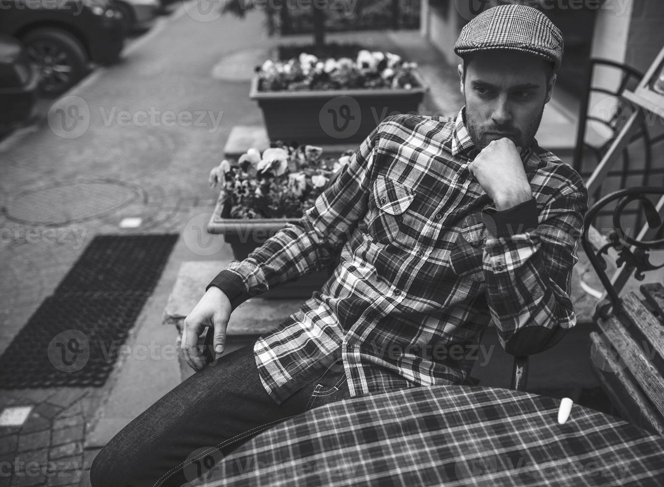 The man in the authentic boots and selvedge jeans  sitting at the table photo
