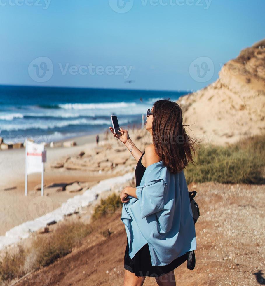 Young woman take a photo on smartphone