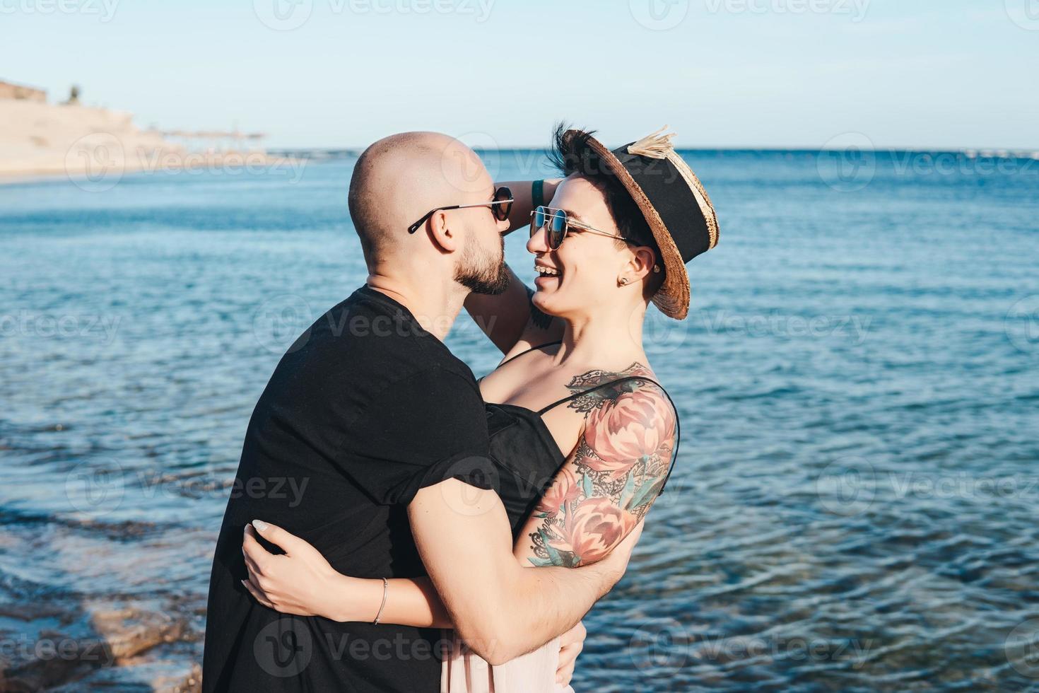 Couple in love embracing each other on beach photo