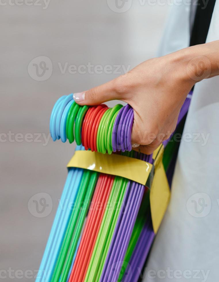 Female hand holding a set of hangers photo