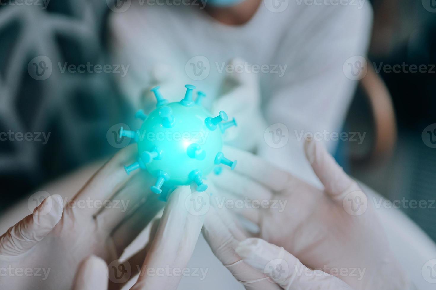 Scientist virologist holding model of new Coronavirus or COVID-19 photo