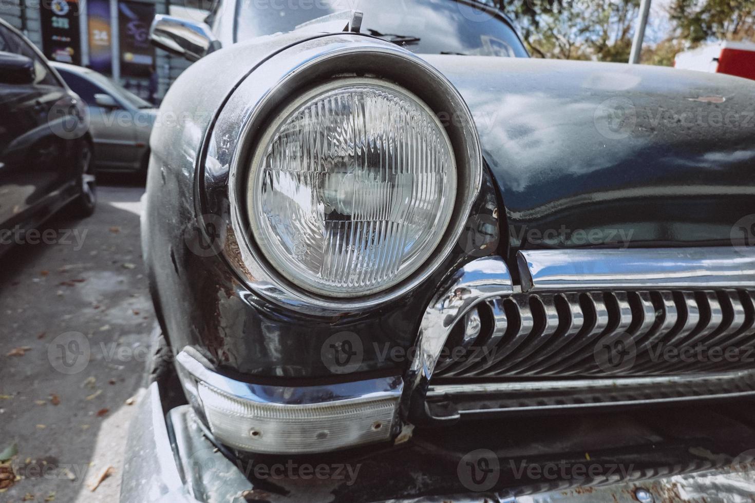 Front headlight of an old soviet automobile gas 21 photo