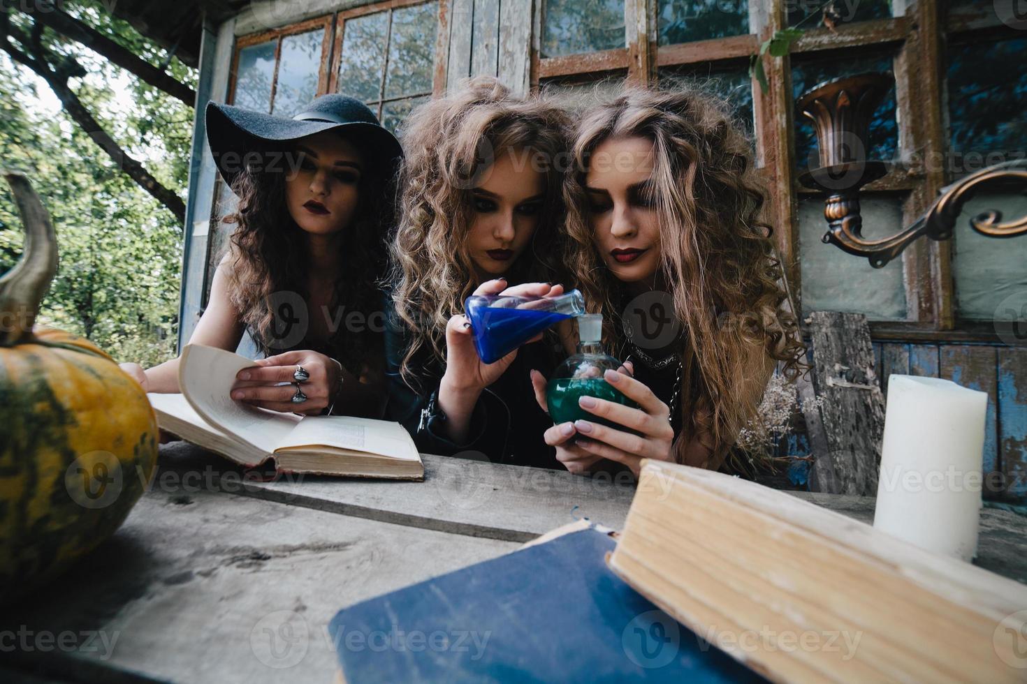 Three vintage witches perform magic ritual photo