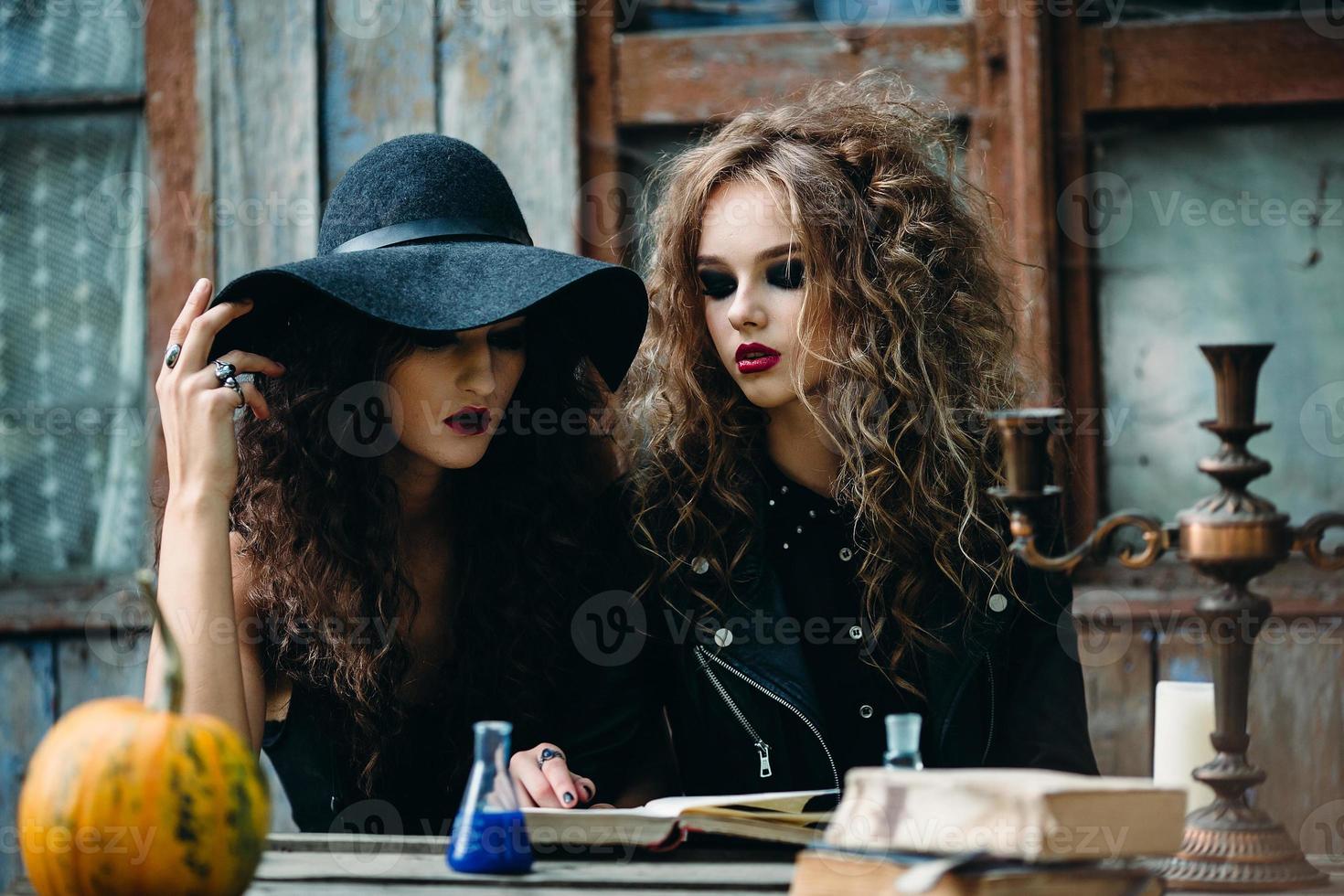 Two vintage witch sitting at the table photo