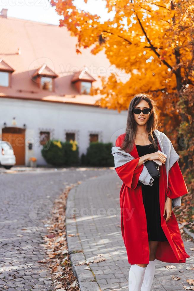 Fashion portrait of beautiful woman in autumn park photo