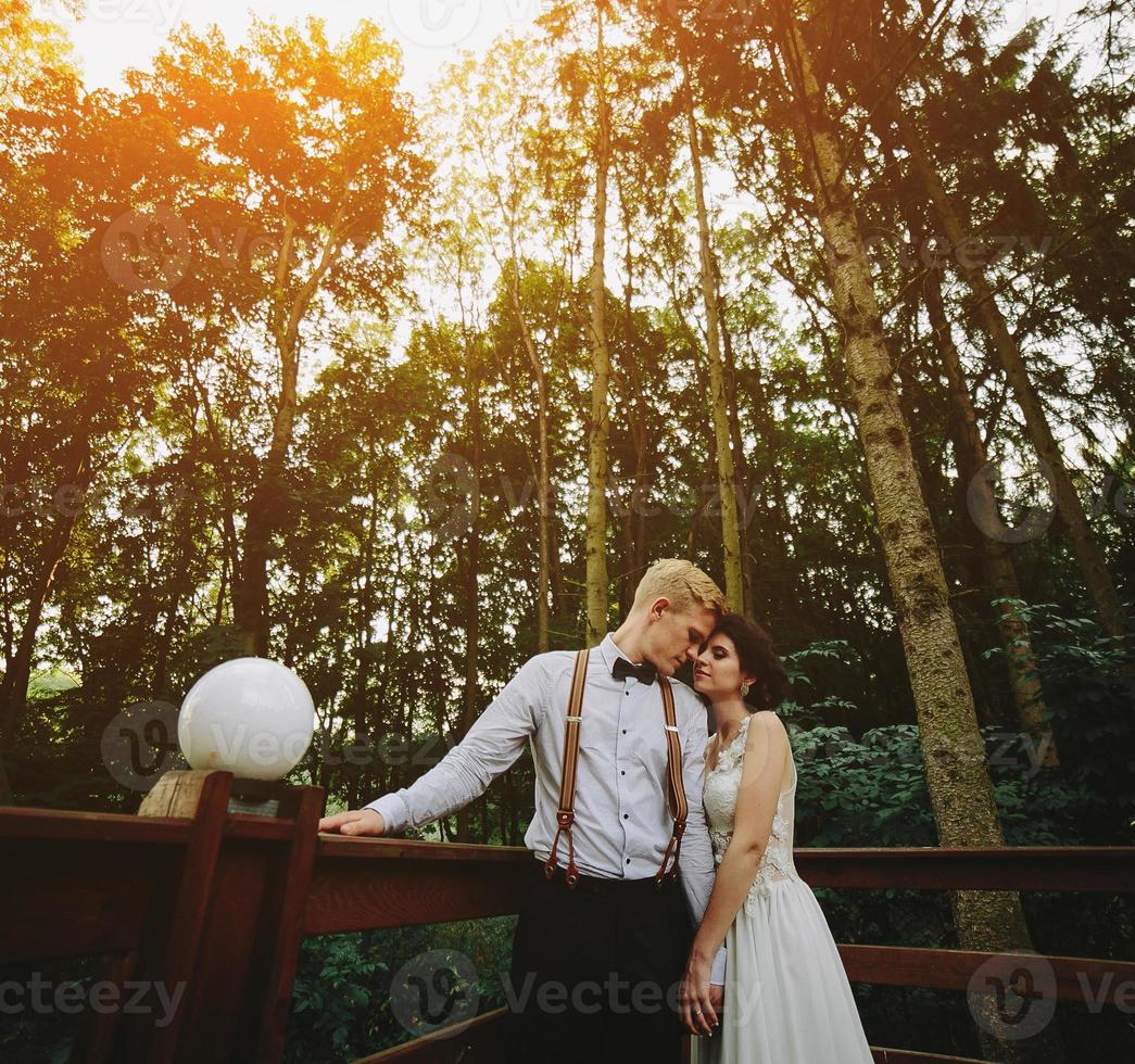bride and groom posing on the verandah photo