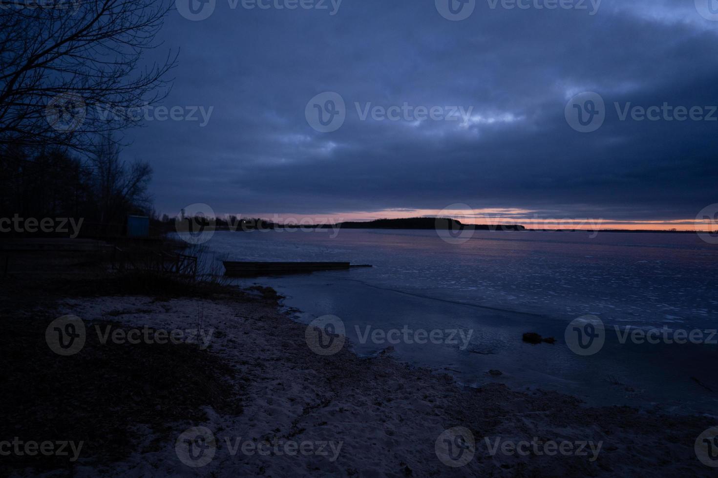 beautiful cold sunrise over a frozen lake photo
