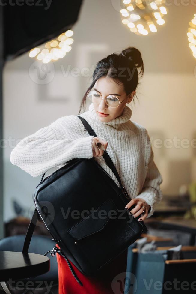 Fashionable woman hold black bag photo