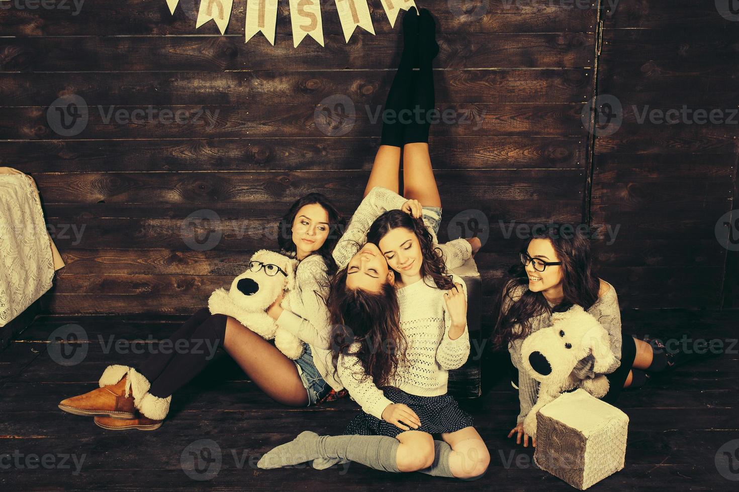 Four charming model posing on a vintage New Year's background photo