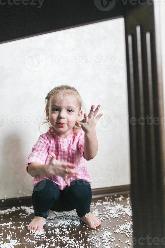 Little girl is playing with foam balls photo