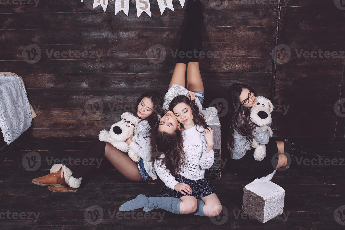 Four charming model posing on a vintage New Year's background photo