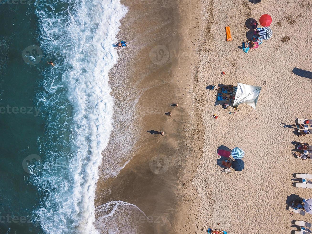 Beach with sun loungers on the coast of the ocean photo