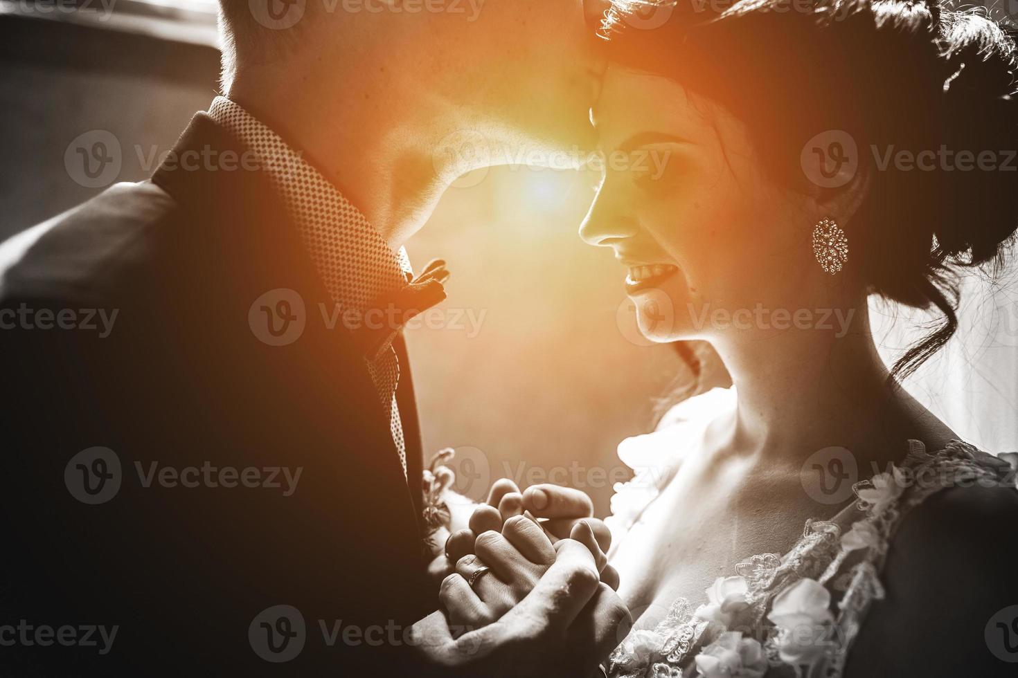 bride and groom on the background of a window. photo