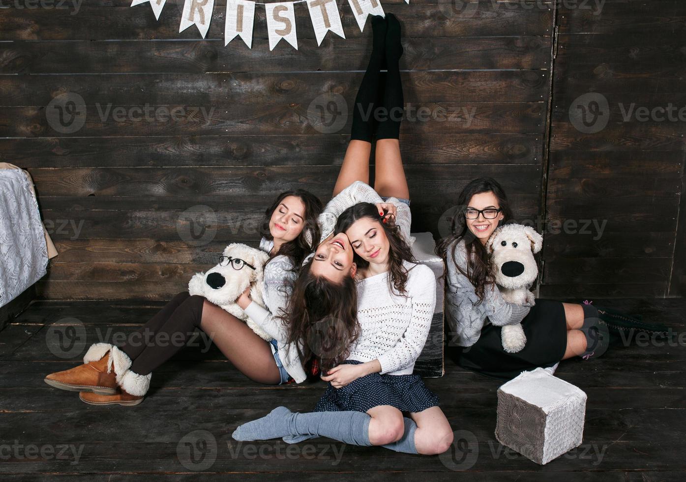 Four charming model posing on a vintage New Year's background photo