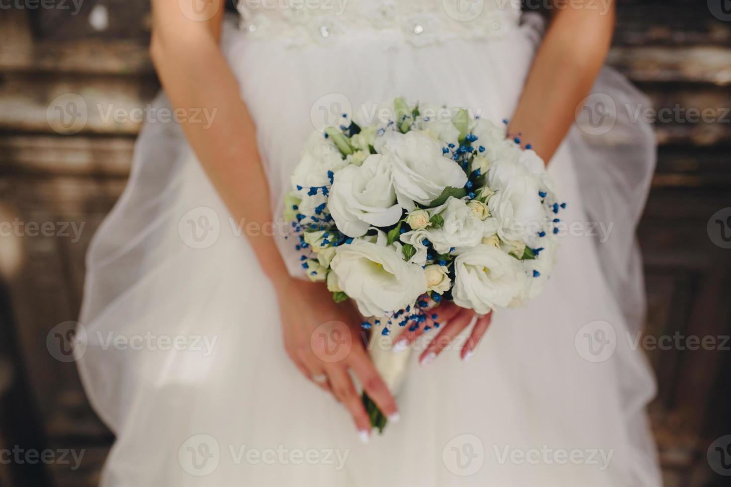 bride holding beautiful wedding bouquet photo