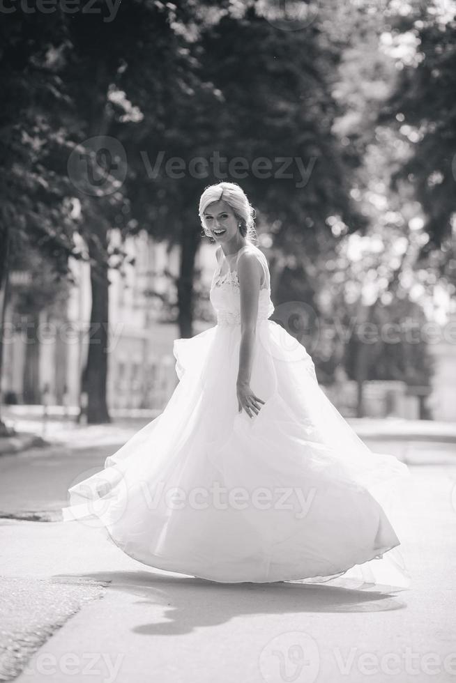 Young beautiful bride posing outdoors photo