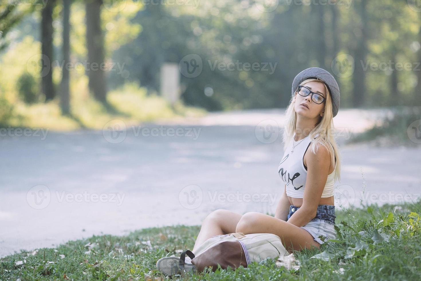 pretty girl sitting and looking at the camera photo