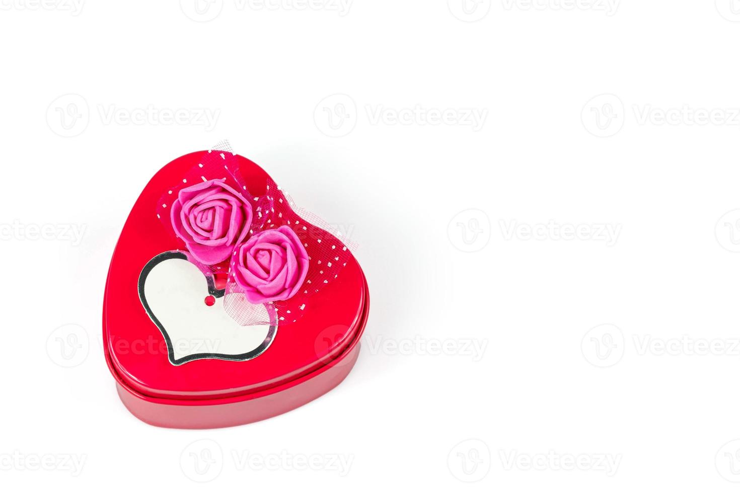 Heart-shaped iron box, decorated with pink artificial flowers, and a greeting card isolated on white background with Clipping path photo
