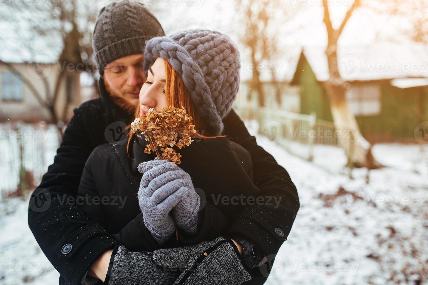 man hugging his girlfriend on the street photo