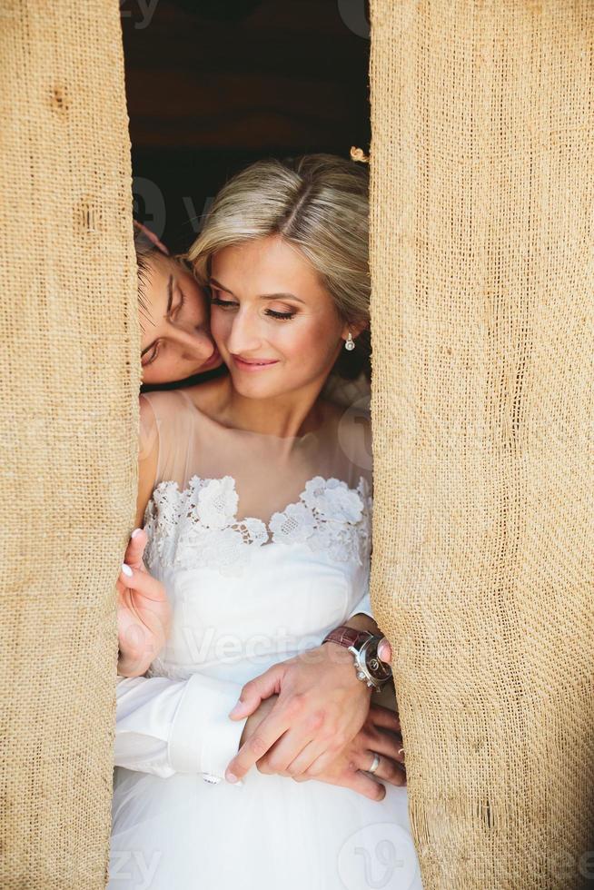 Beautiful wedding couple in doorway photo
