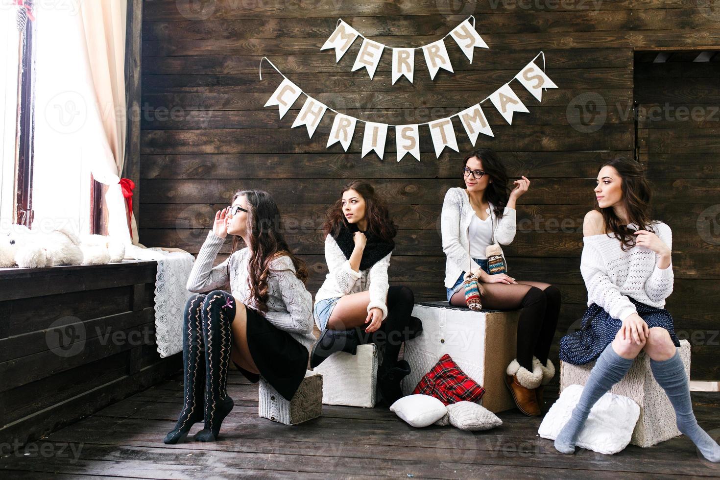 Four charming model posing on a vintage New Year's background photo
