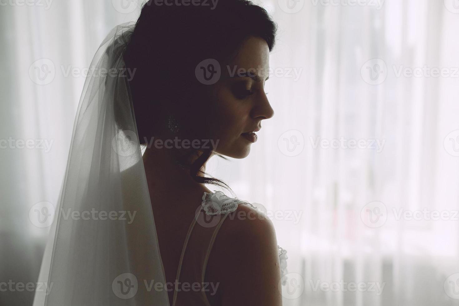 Bride posing in a large window photo