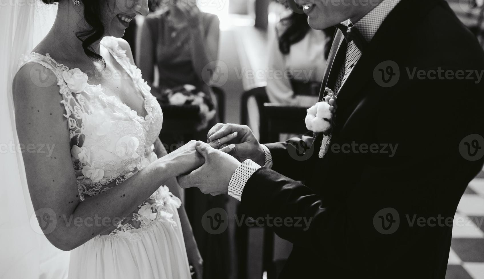 Putting the wedding ring on photo