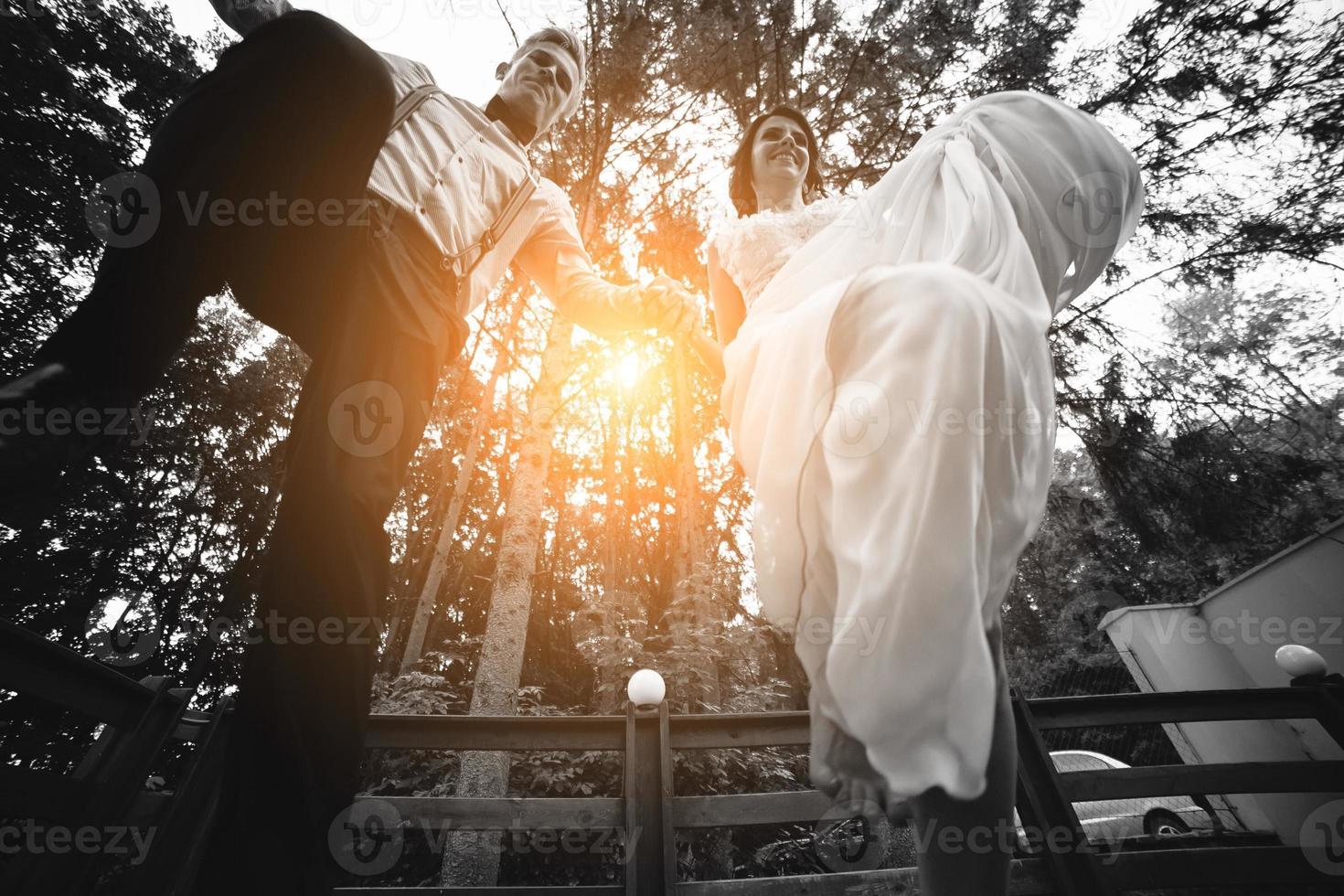 bride and groom jumping, having fun photo