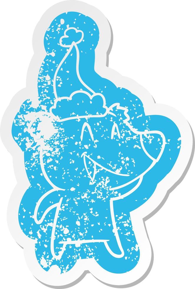 laughing bear cartoon distressed sticker of a wearing santa hat vector