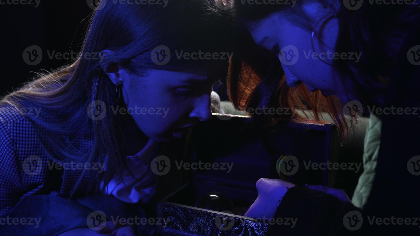 Woman and fortune teller with crystal ball photo