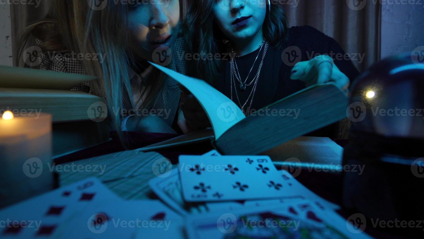 Two women are reading a mysterious book photo