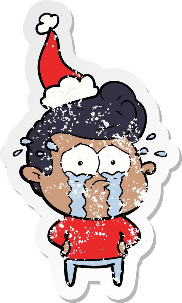 distressed sticker cartoon of a crying man wearing santa hat vector