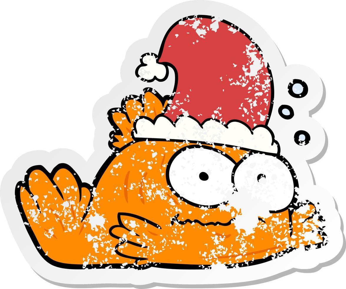 distressed sticker of a cartoon goldfish wearing xmas hat vector