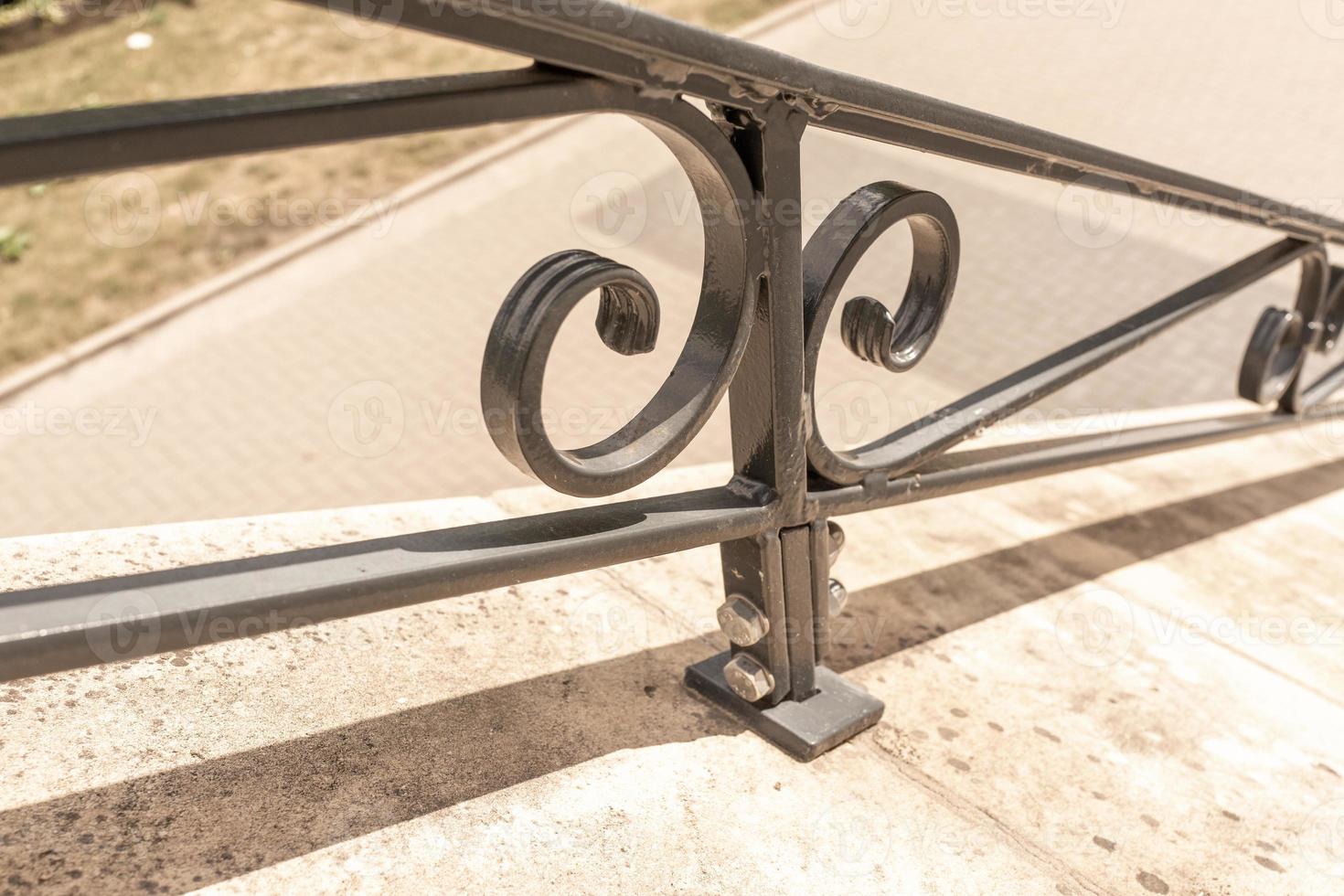 stairs with cast iron railing outside photo