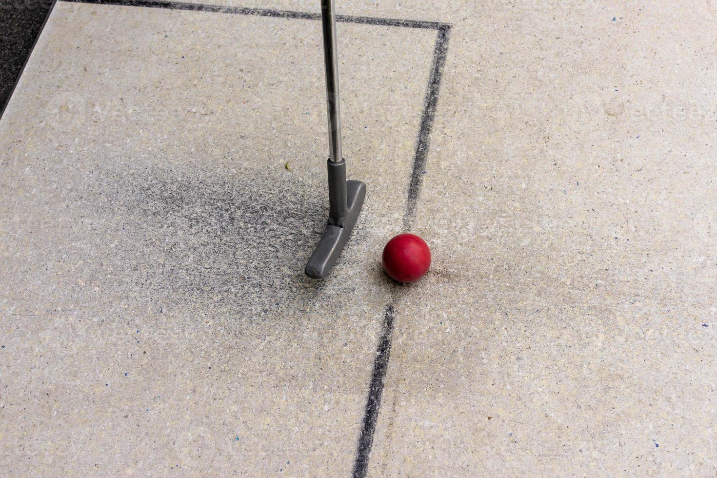 Miniature golf club with red ball photo