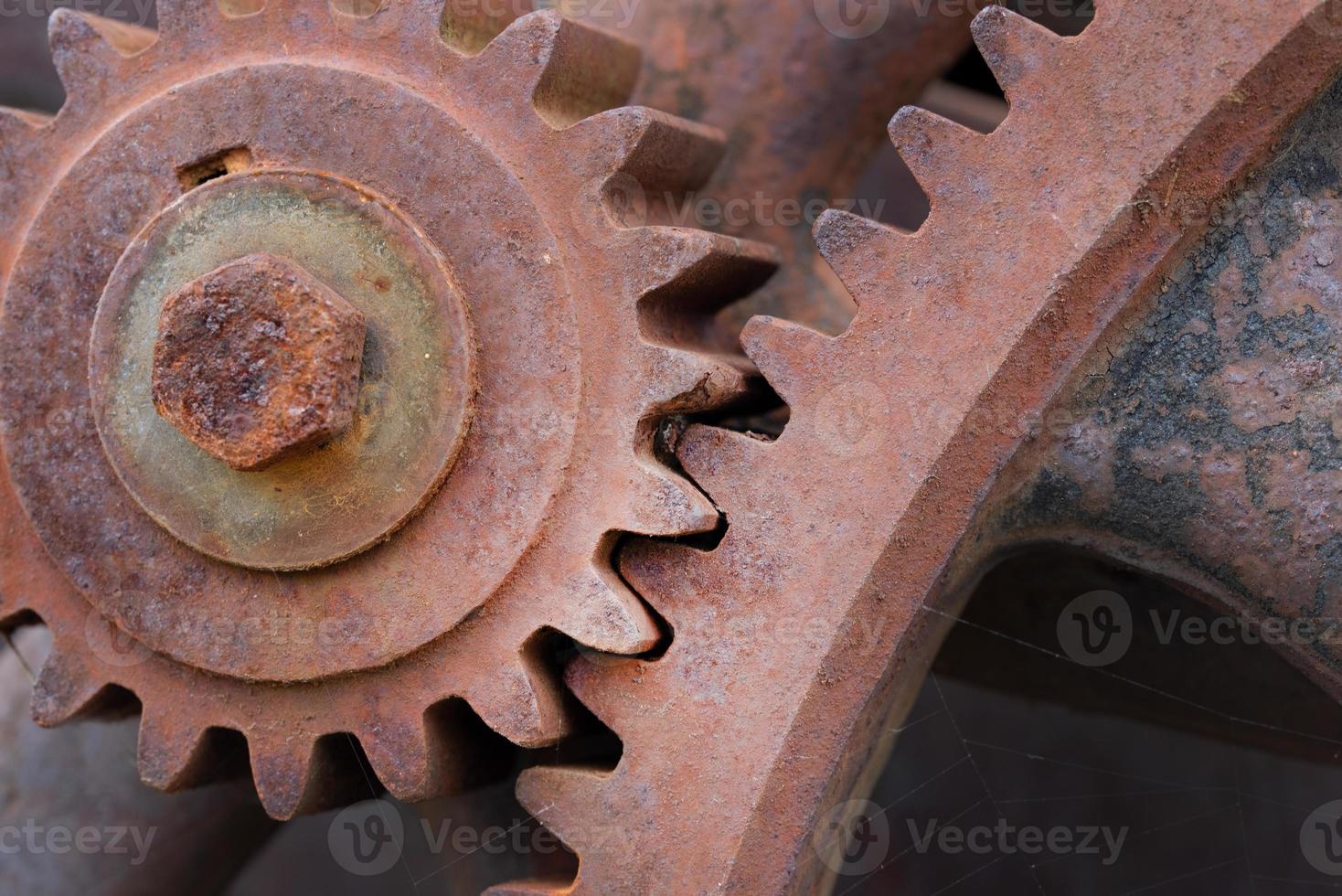 Close up of rusty gears interlocking on a machine photo