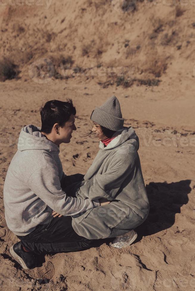 A man and a woman enjoy each other on the seashore. photo