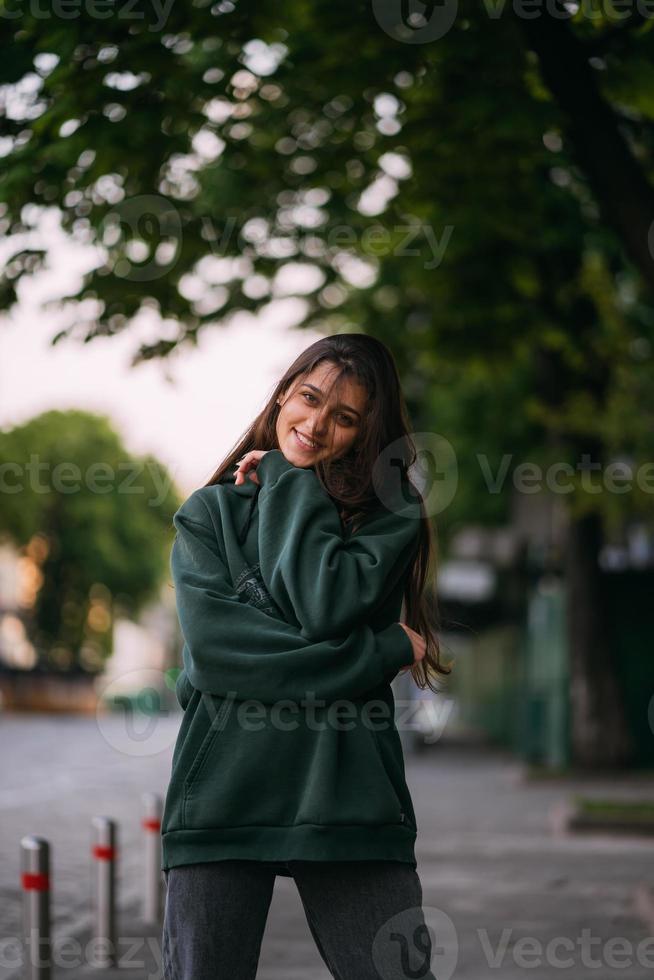 Portrait of cute girl with long hair looks at the camera photo