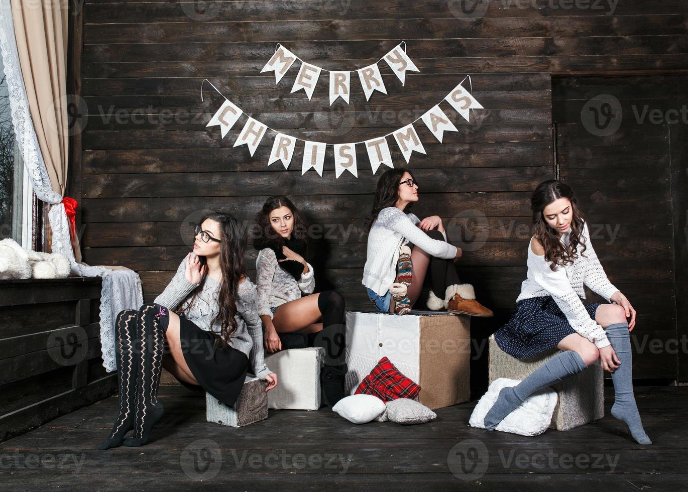 Four charming model posing on a vintage New Year's background photo