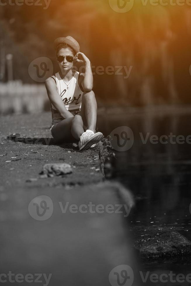 beautiful girl sitting on the pier photo