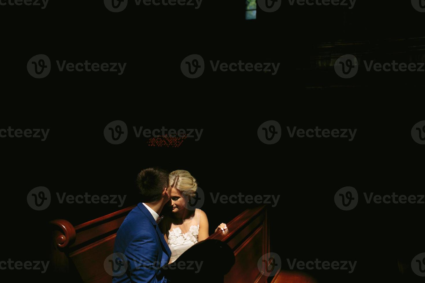 bride and groom illuminated by light photo