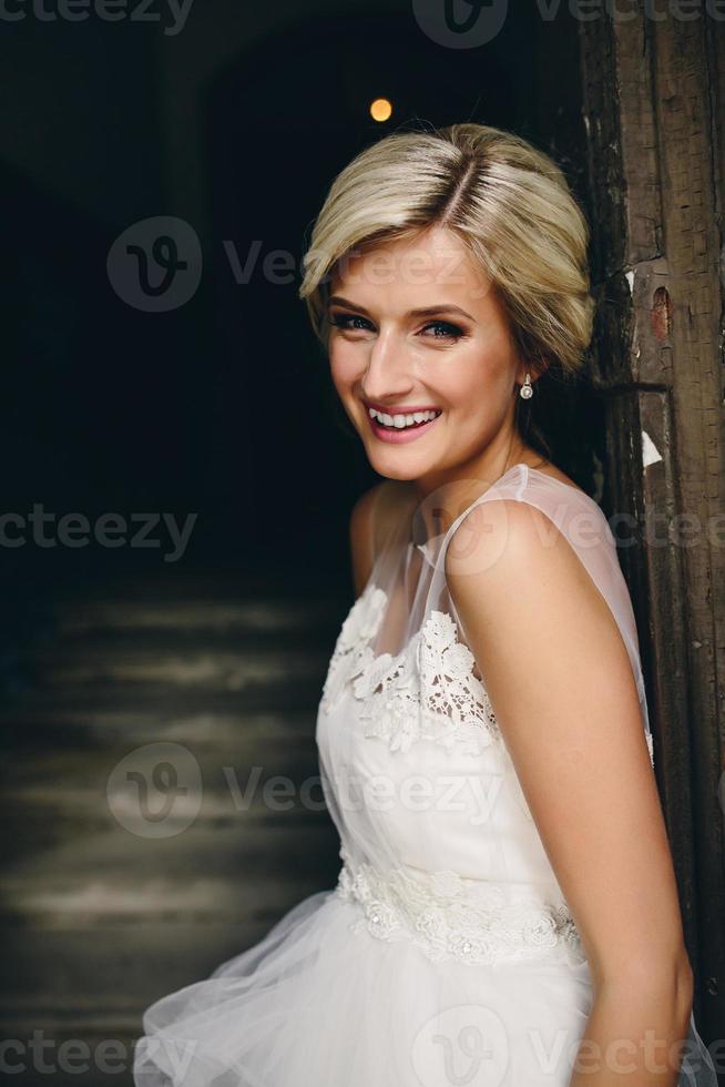 bride standing in front of the old door photo