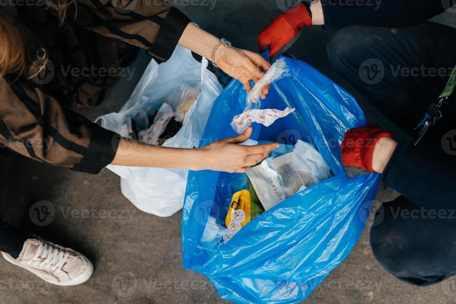 Two perrson sorting garbage. Concept of recycling. Zero waste photo