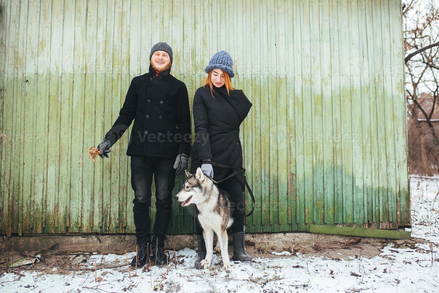 man and woman with dog photo