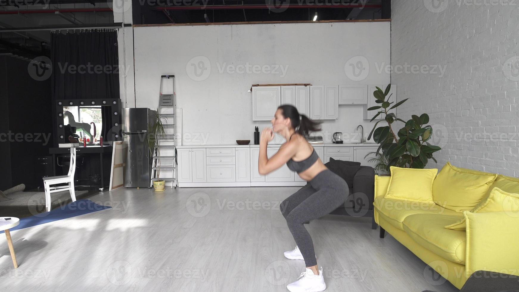 Beautiful young woman doing fitness at home photo